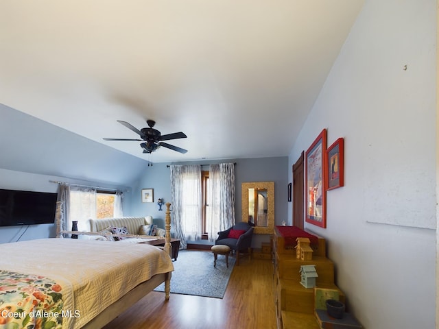 bedroom with multiple windows, hardwood / wood-style floors, vaulted ceiling, and ceiling fan