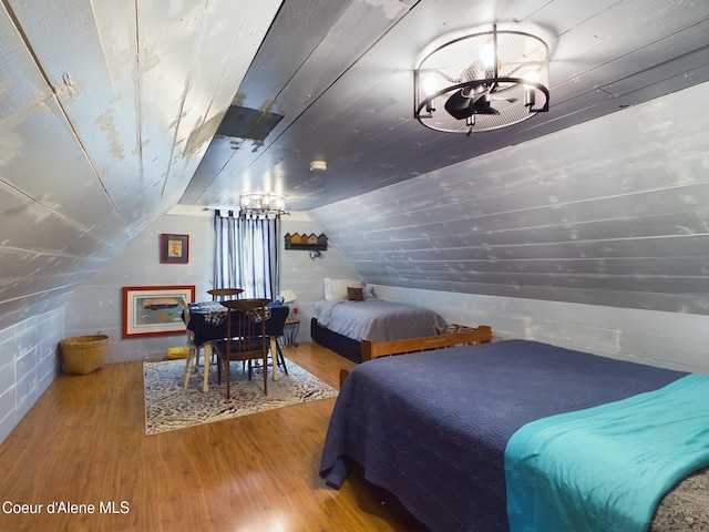 bedroom featuring an inviting chandelier, hardwood / wood-style flooring, vaulted ceiling, and wooden ceiling