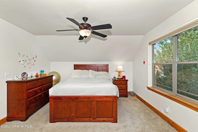 bedroom with vaulted ceiling, light carpet, and ceiling fan