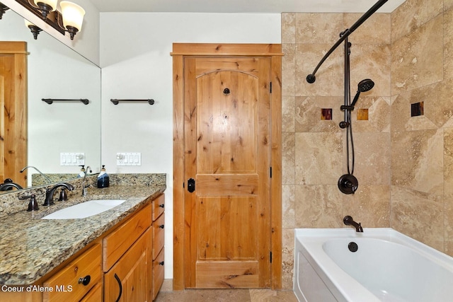 bathroom featuring tiled shower / bath combo and vanity
