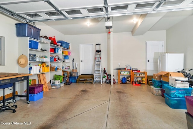 garage with white refrigerator and a garage door opener