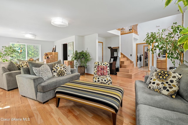 living room featuring washer / clothes dryer and light hardwood / wood-style floors