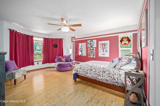 bedroom with wood-type flooring and ceiling fan