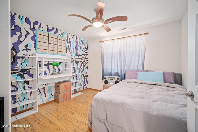 bedroom with wood-type flooring and ceiling fan