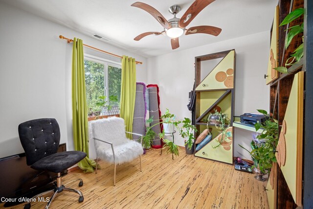 living area with ceiling fan and light wood-type flooring