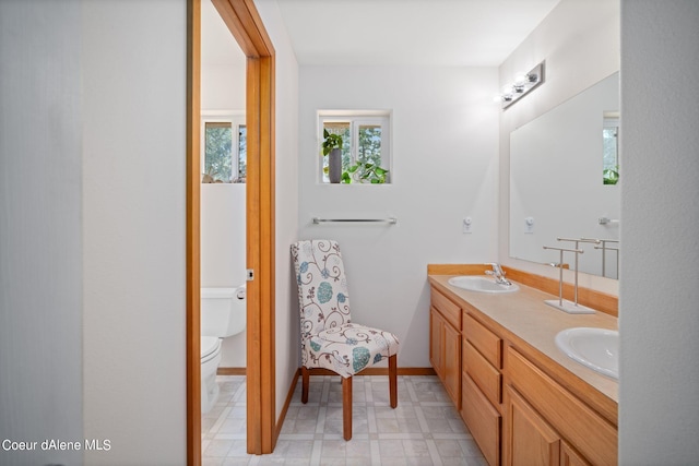 bathroom featuring vanity and toilet