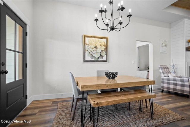 dining space featuring an inviting chandelier and dark hardwood / wood-style floors