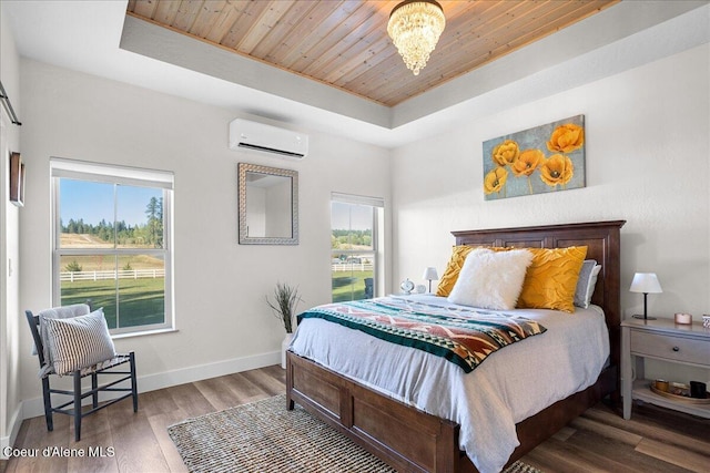 bedroom with wood ceiling, a wall mounted air conditioner, wood-type flooring, a chandelier, and a tray ceiling