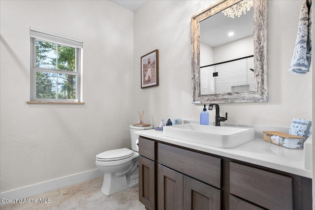 bathroom featuring vanity, toilet, and walk in shower