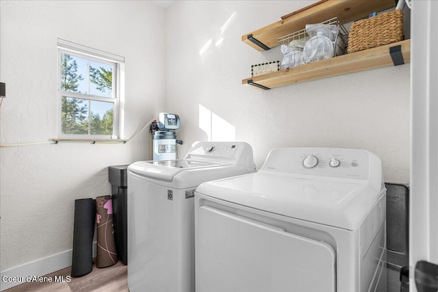 laundry area featuring separate washer and dryer and light wood-type flooring