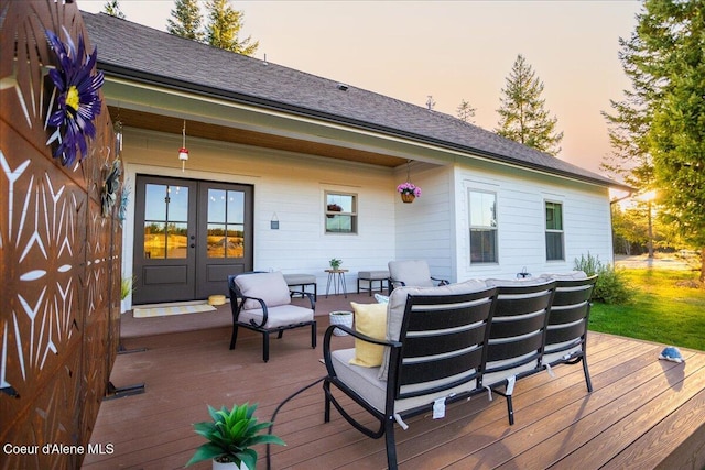 deck at dusk featuring an outdoor hangout area and french doors