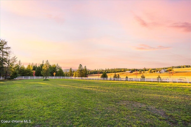 yard at dusk with a rural view