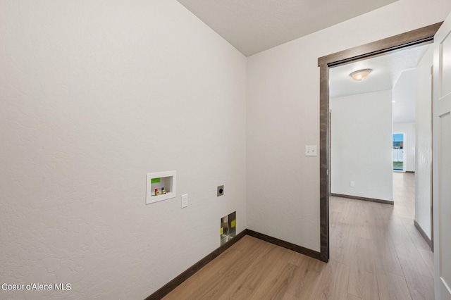 clothes washing area featuring electric dryer hookup, washer hookup, and light hardwood / wood-style flooring