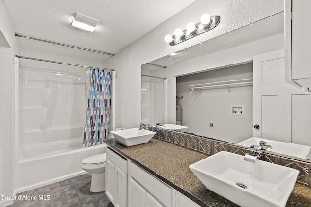 full bathroom with shower / tub combo with curtain, vanity, a textured ceiling, tile patterned floors, and toilet