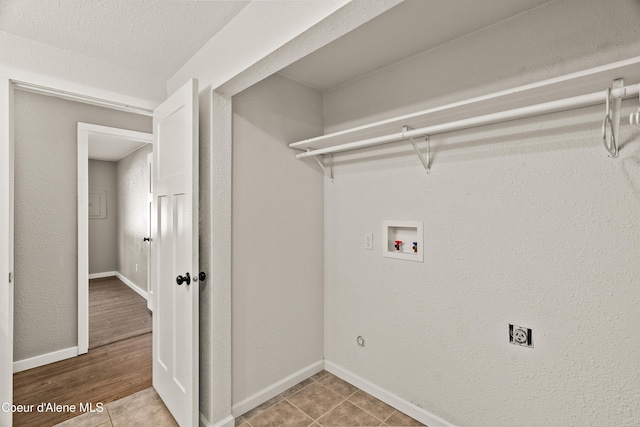 washroom with tile patterned floors, washer hookup, and electric dryer hookup