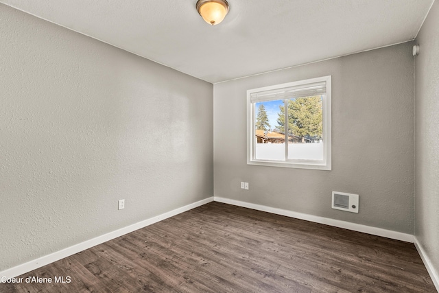 unfurnished room featuring dark hardwood / wood-style flooring