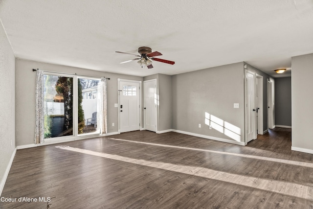 foyer entrance featuring ceiling fan, dark hardwood / wood-style flooring, and a textured ceiling