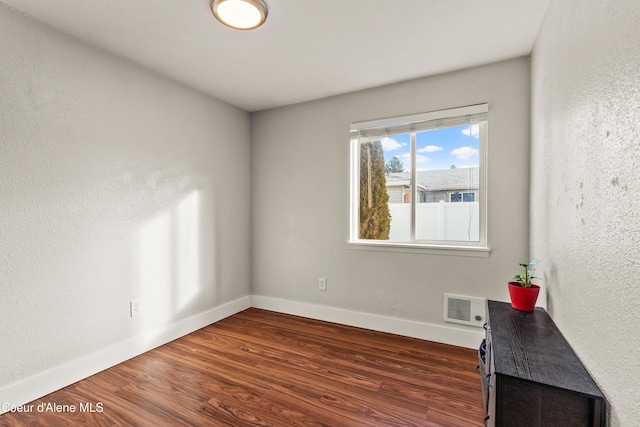 empty room with dark wood-type flooring