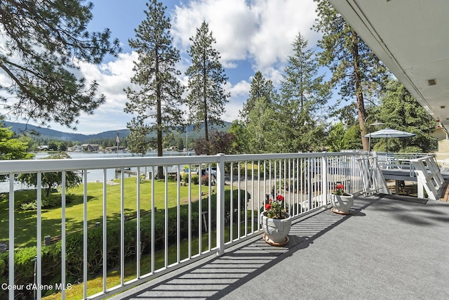 balcony featuring a water and mountain view