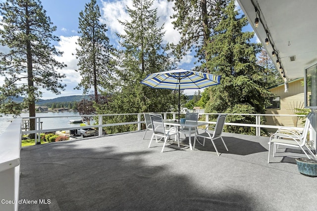 view of patio / terrace featuring a water and mountain view