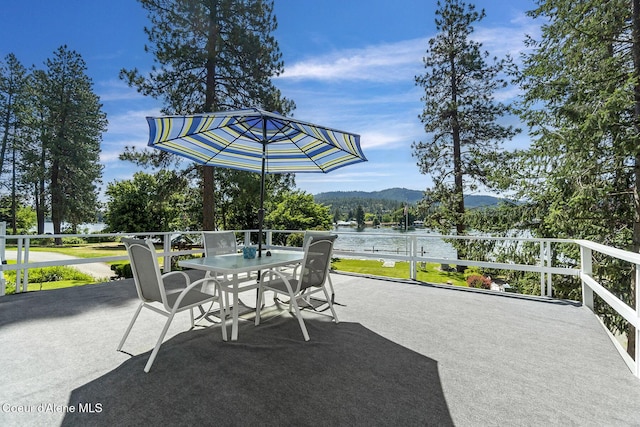 view of patio / terrace with a water and mountain view