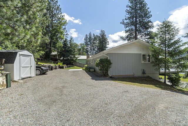 view of side of property featuring a storage unit