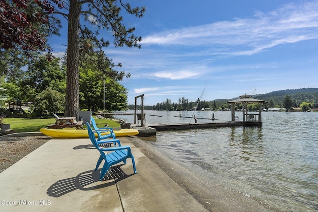 view of dock with a gazebo and a water view