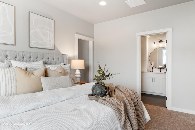 carpeted bedroom featuring recessed lighting, visible vents, connected bathroom, and baseboards