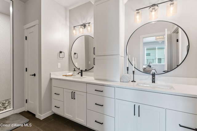 full bathroom with baseboards, double vanity, a sink, and tile patterned floors