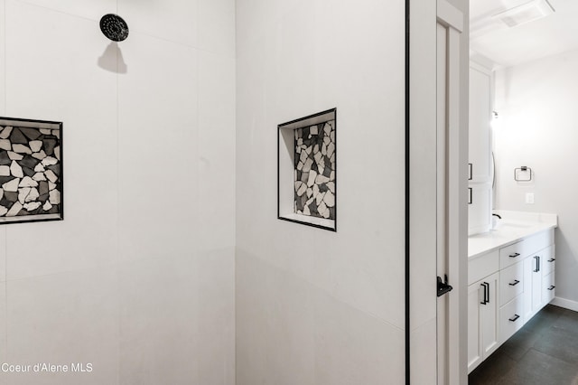 bathroom with vanity and a shower