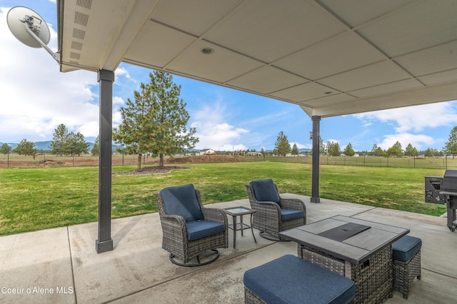 view of patio / terrace with a rural view, outdoor lounge area, and fence