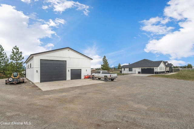 detached garage with driveway and fence