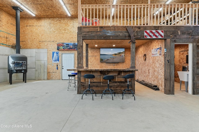 kitchen featuring a towering ceiling and concrete flooring