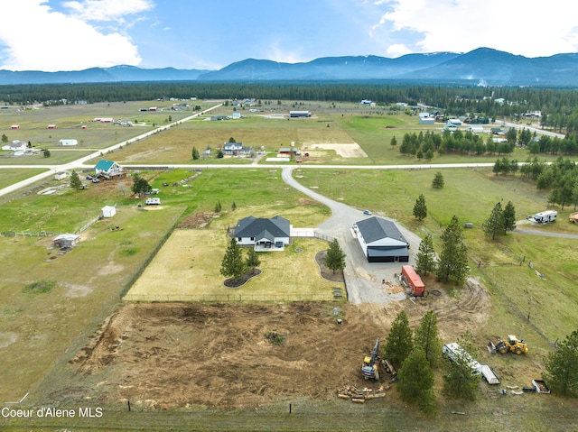 birds eye view of property featuring a mountain view and a rural view