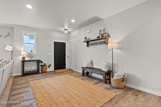 entrance foyer featuring baseboards, wood finished floors, and recessed lighting