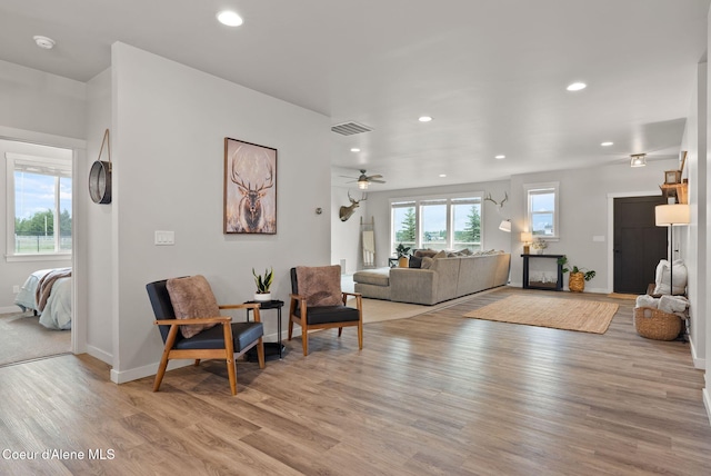living area featuring recessed lighting, baseboards, light wood finished floors, ceiling fan, and visible vents