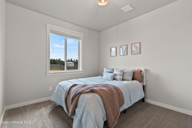 carpeted bedroom featuring baseboards and visible vents