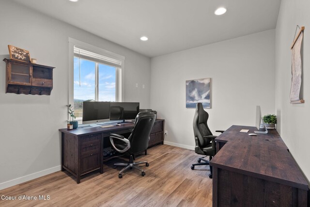 home office featuring light wood finished floors, baseboards, and recessed lighting