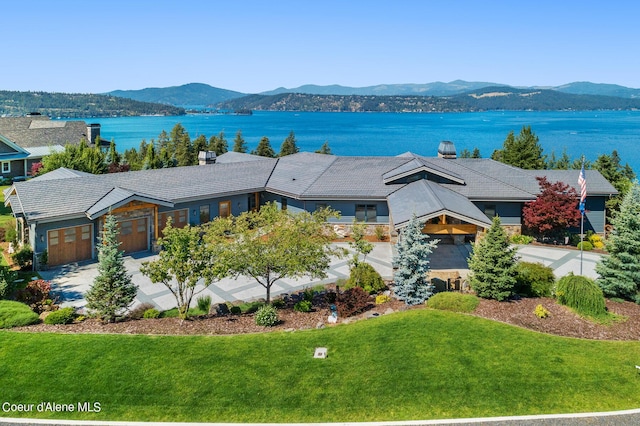 birds eye view of property with a water and mountain view