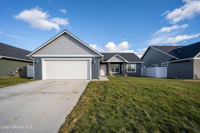 view of front of home with a garage and a front lawn