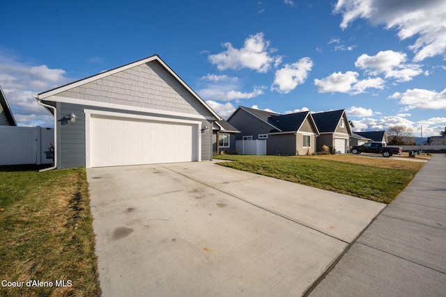 view of front of home featuring a garage and a front yard