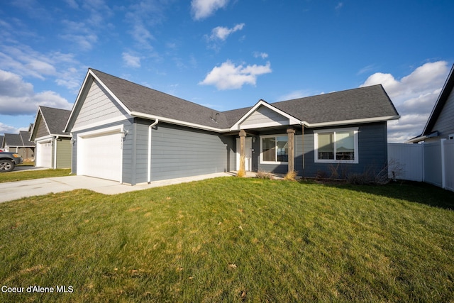 ranch-style home featuring a garage and a front lawn