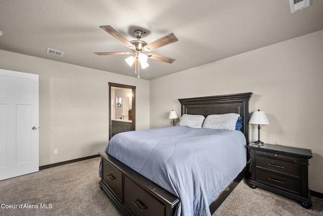 bedroom featuring ensuite bathroom, light carpet, and ceiling fan