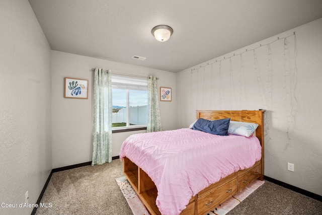 carpeted bedroom with a textured ceiling