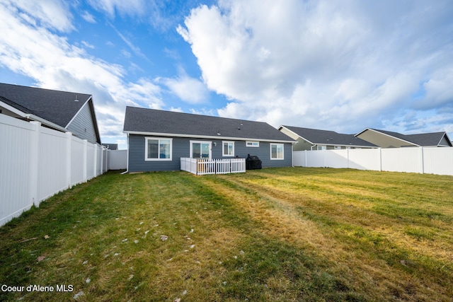 rear view of house featuring a lawn