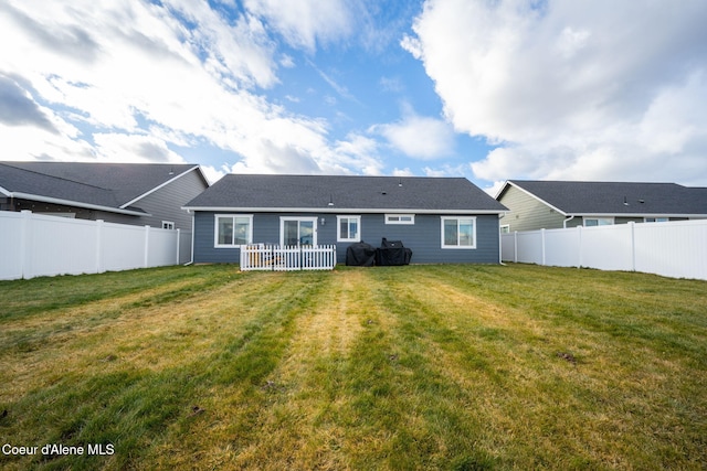 rear view of house with a yard