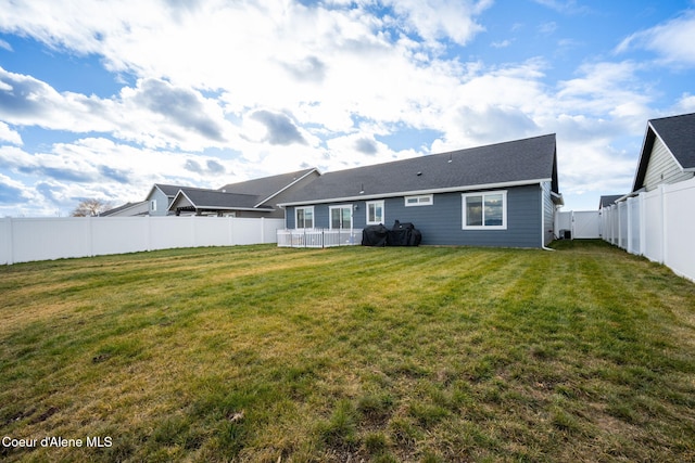 rear view of property with a lawn