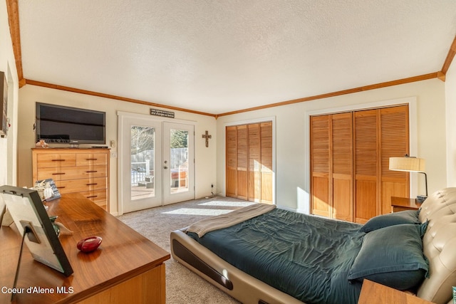 carpeted bedroom with crown molding, access to outside, a textured ceiling, and french doors