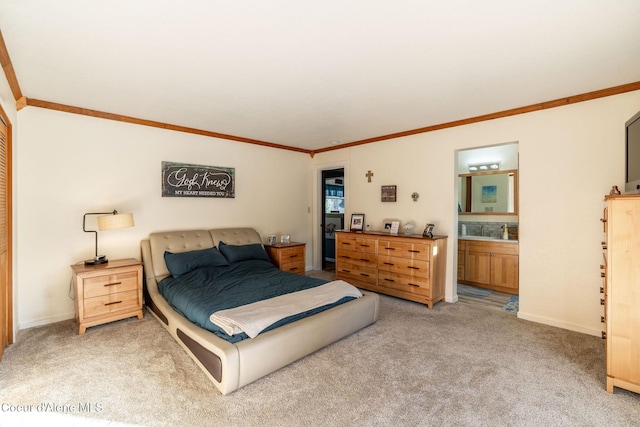 carpeted bedroom featuring ornamental molding and ensuite bathroom