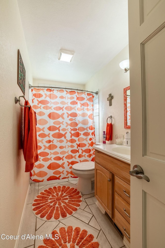 bathroom with walk in shower, vanity, and toilet